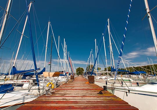 A dock with many boats parked on it